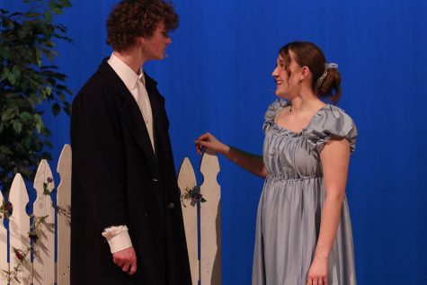 Elizabeth Bennett smiles at Mr. Darcy while theyre out in the garden. 