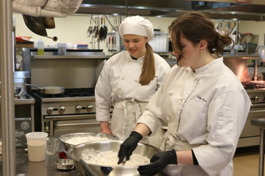 In their Culinary Arts I class at Eudora, juniors Ashlyn Bellmyer and Lily Jensen prepare pizza dough to be made later in the week Wednesday, April 6.
