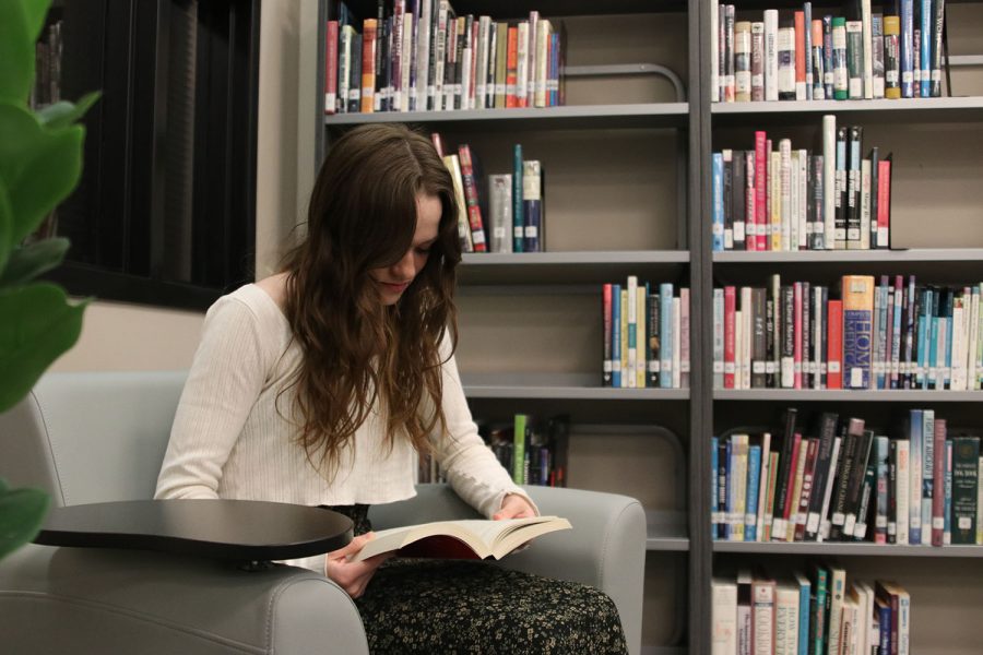 Sitting in the media center before school, freshman Avery Clement reads a copy of Catching Fire, the second literary installment in the Hunger Games trilogy.