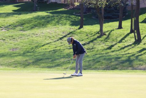 Head down, sophomore Brett Spandet focuses on his putt. 