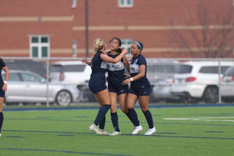 After scoring a goal, junior Shelby Kindt is hugged by senior Hadley Lockhart and junior Brooke Bellehumeur. 
