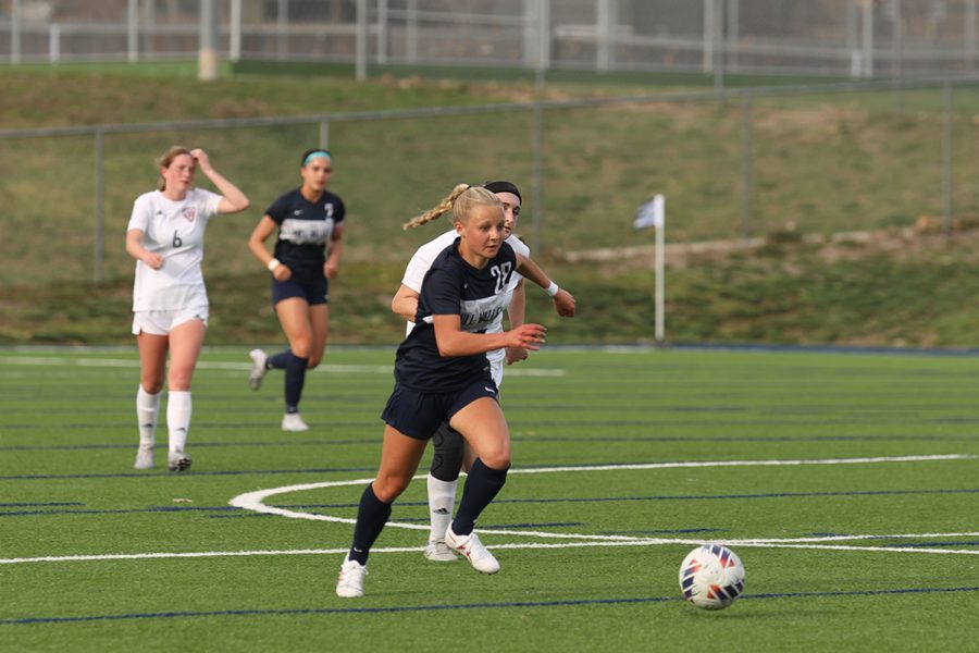 Freshman Jenna Lloyd dribbles away from the defender. 