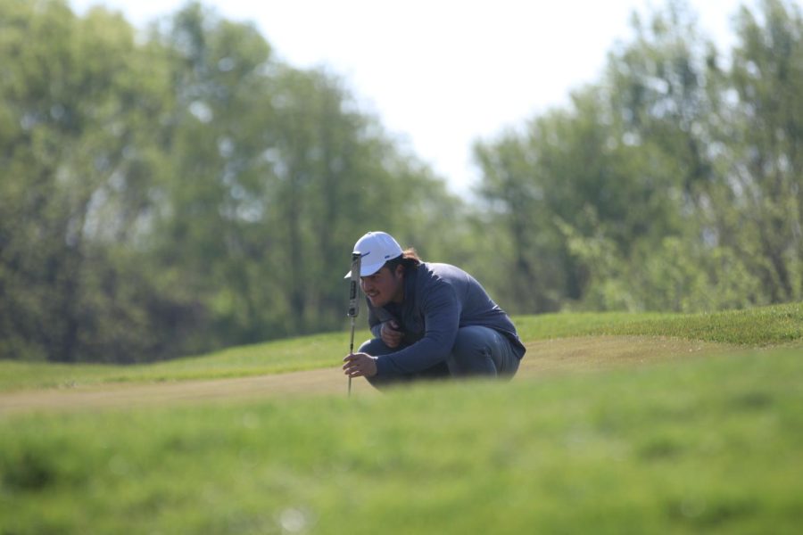 Lining up his shot, senior Karson Chalupnik places the tee.
