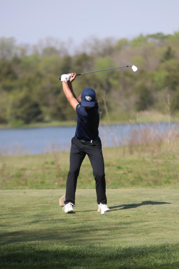 Mid-swing, sophomore Jackson Sprecker keeps his eyes on the ball.