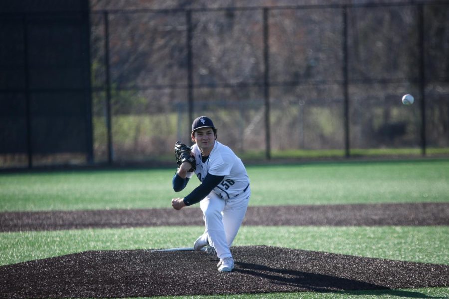 Senior Parker Volski makes a big stride after pitching the ball on the pitchers mound.