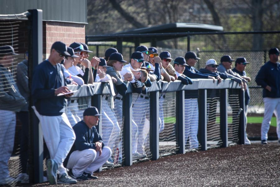 The rest of the team watches anxiously while those on the field make their next play.