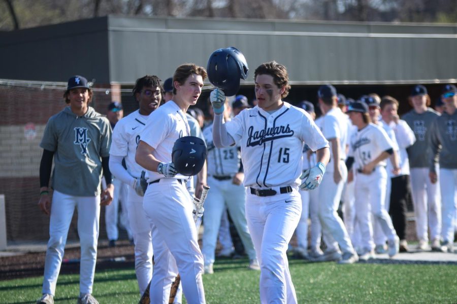 After hitting a home run, junior Reid Livingston gets congratulated by his teammates. 