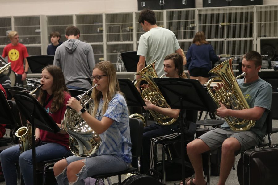 Before band class starts, senior Madison Koester, sophomore Marissa Akehurst, senior Brody Shulda and junior Ben Hansen play a phrase of their contest song that features the low brass section.