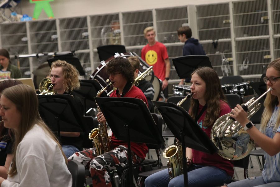 In preparation for regionals, junior Evan Mack, junior Trent Richardson and senior Madison Koester play a short section of their regionals performance song. 