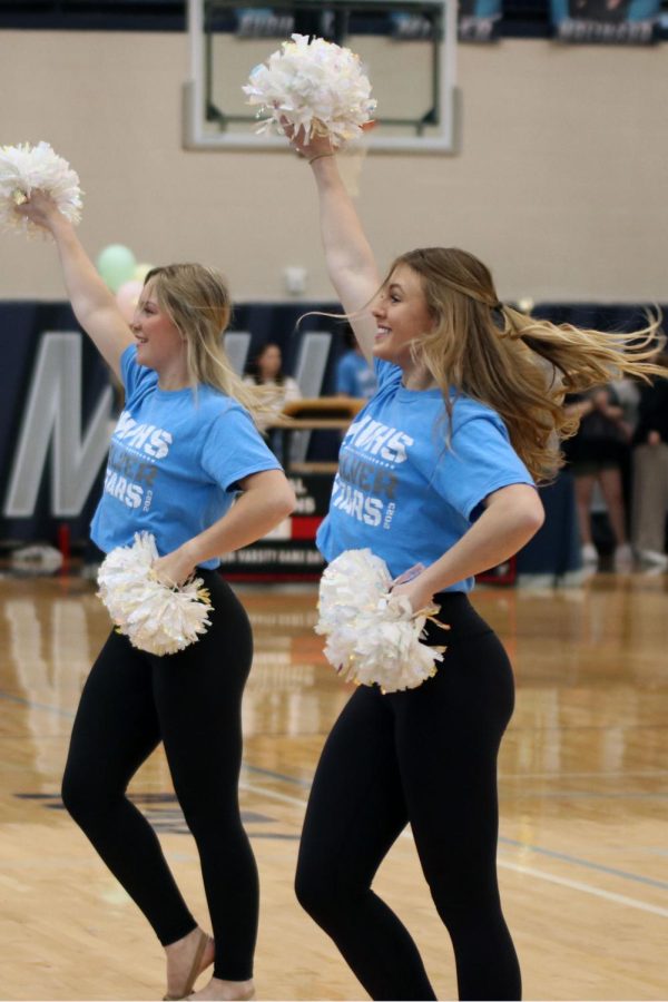 Smiling to the crowd, junior Halle Wampler dances to the fight song. 
