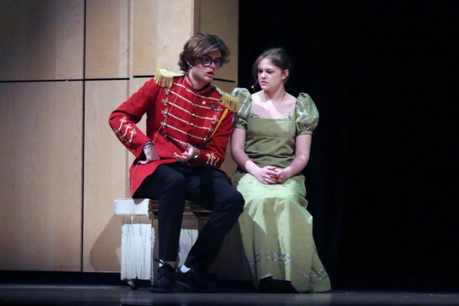 Sitting on a bench, Mr. Wickham, played by senior Atticus OBrien, and Elizabeth Bennett, played by junior Caroline Alley, discuss Mr. Darcy. 