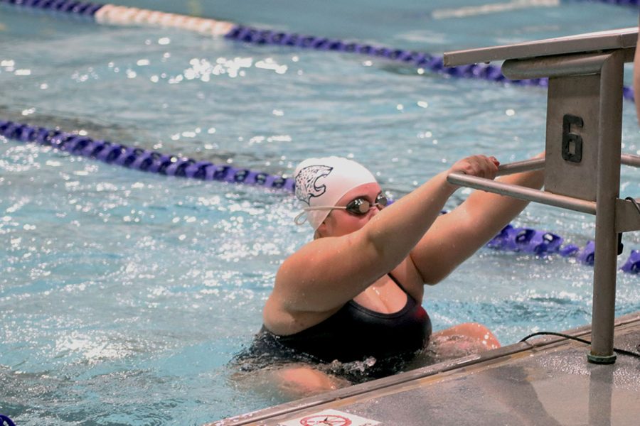 Getting into the water, junior Kate Haney prepares herself to compete.