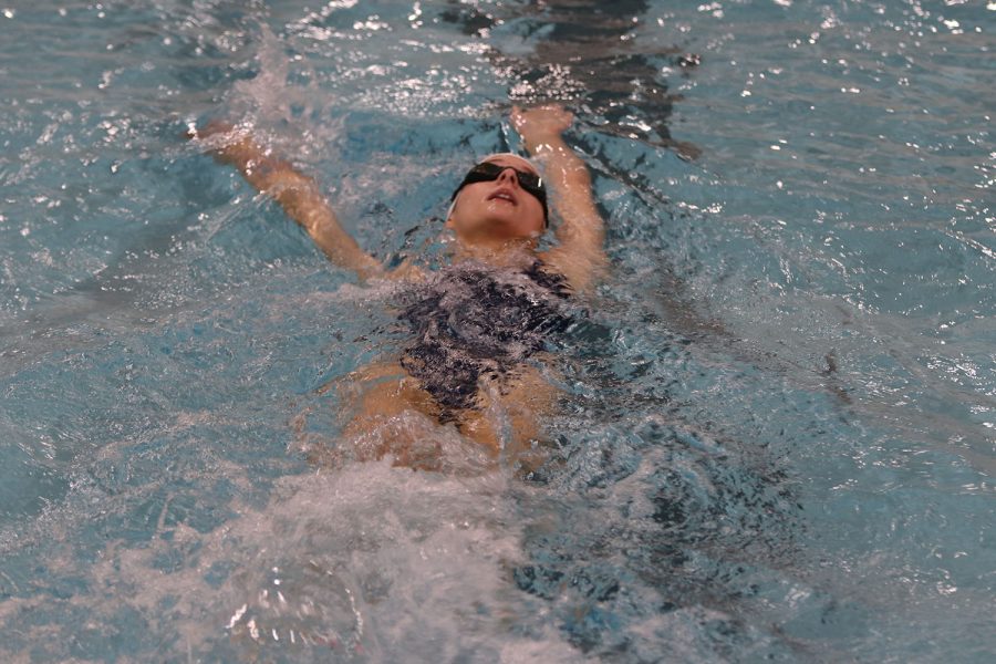 Gliding to through the water, freshman McKenzie Clifton swims with a backhand stroke. 