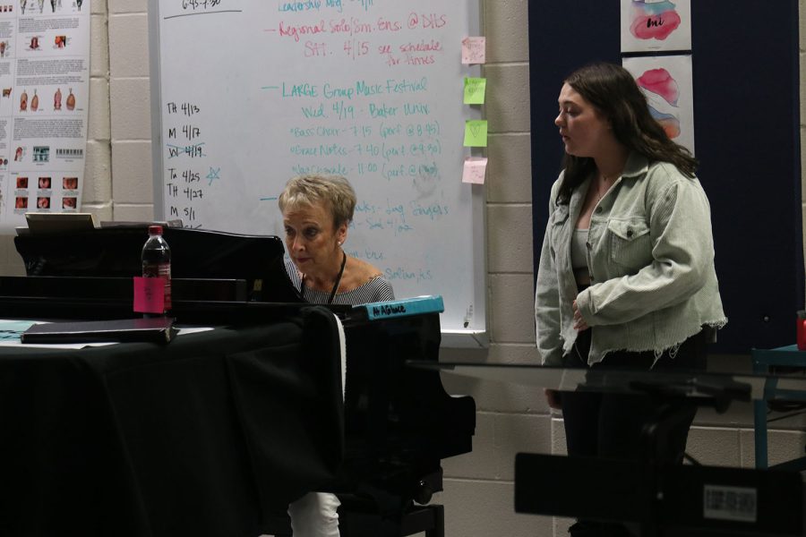 Working with a guest choir director, junior McKinley Graves gets advice for her choir regionals solo. Graves received a I superior rating on her solo.