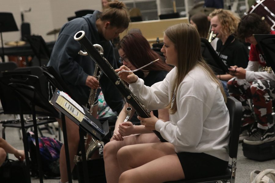 During warm up time at the beginning of band class, junior Kate Martin tunes her bassoon.