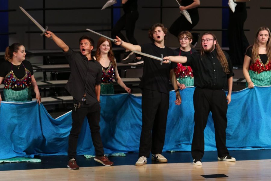 Pointing their swords to the crowd, senior Atticus O’Brien and juniors AJ Lauer and Aiden Ferguson sing “In the Same Boat” from Curtains. 