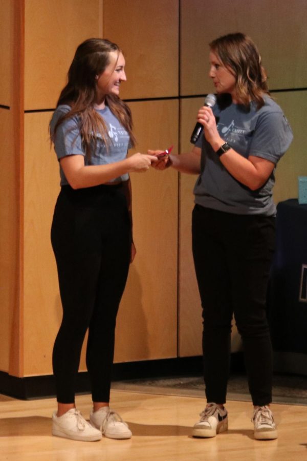 Sophomore Allyson Makalous receives an award from choir teacher Jessie Reimer for choreographing the dances. 
