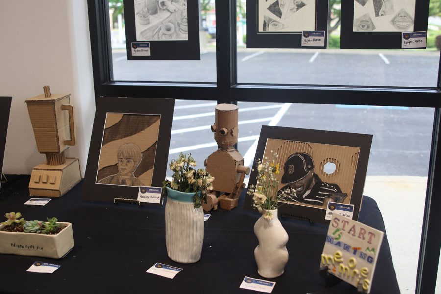 Art by seniors Atticus OBrien and Madeline Hanna and sophomore Ayden Brown is displayed alongside other student art. Students from every art class collaborated for the art show.