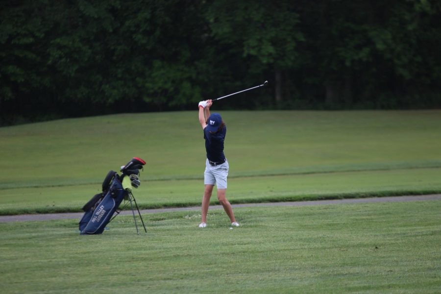 Hands in the air, sophomore Brett Spandet swings his club.