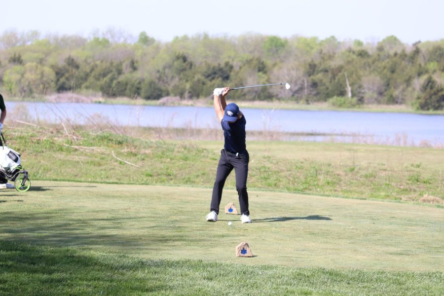 Club drawn back, sophomore Jackson Sprecker begins a swing. 