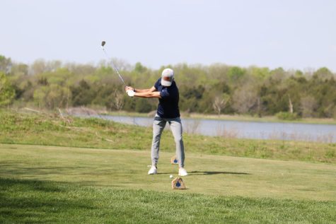 Head down, senior Codey Geis swings his club. 