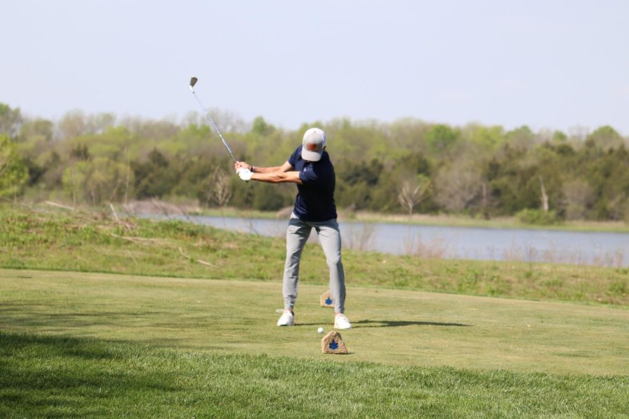 Head down, senior Codey Geis swings his club. 