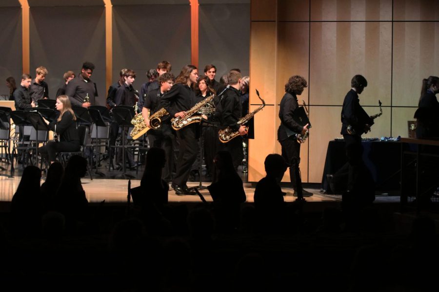 In between performances, members of the concert band file off the stage while members of the symphonic band enter the stage to perform the last few musical pieces of the concert.