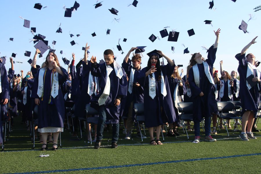 Once hearing the signal, seniors turn their tassels and watch as their caps fly into the air.