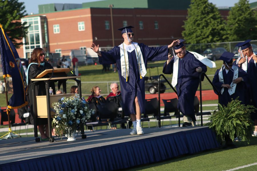 Walking onto the stage, senior Brody Shulda puts his arms out in excitement.