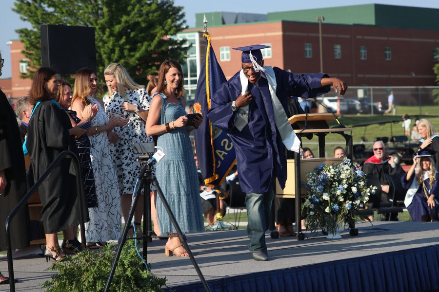 To celebrate before getting his diploma, senior Darrelle Hillmon dances on stage to the audience. 