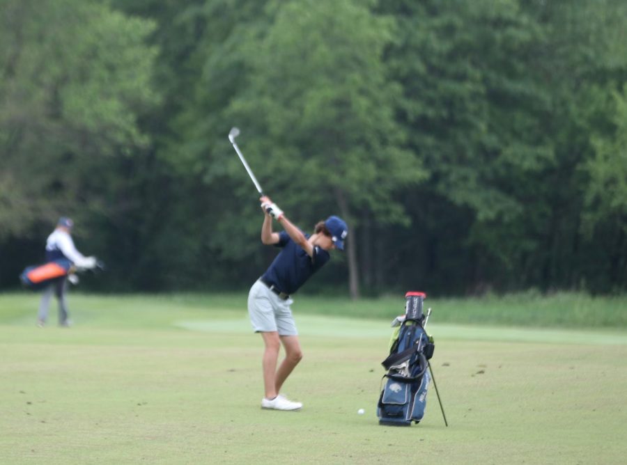  About to start his swing, sophomore Brett Spandett swings the club.
