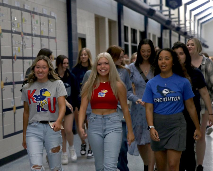 Student body president Bri Coup, senior class president Gabby Delpleash and senior Tierney Fields lead the seniors last walk through the halls.