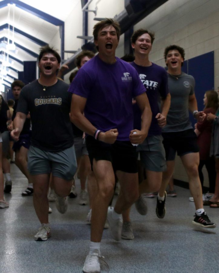 Seniors Parker Volski, Marko Skavo, Dylan Blazer and Mark Bauer run through the halls.