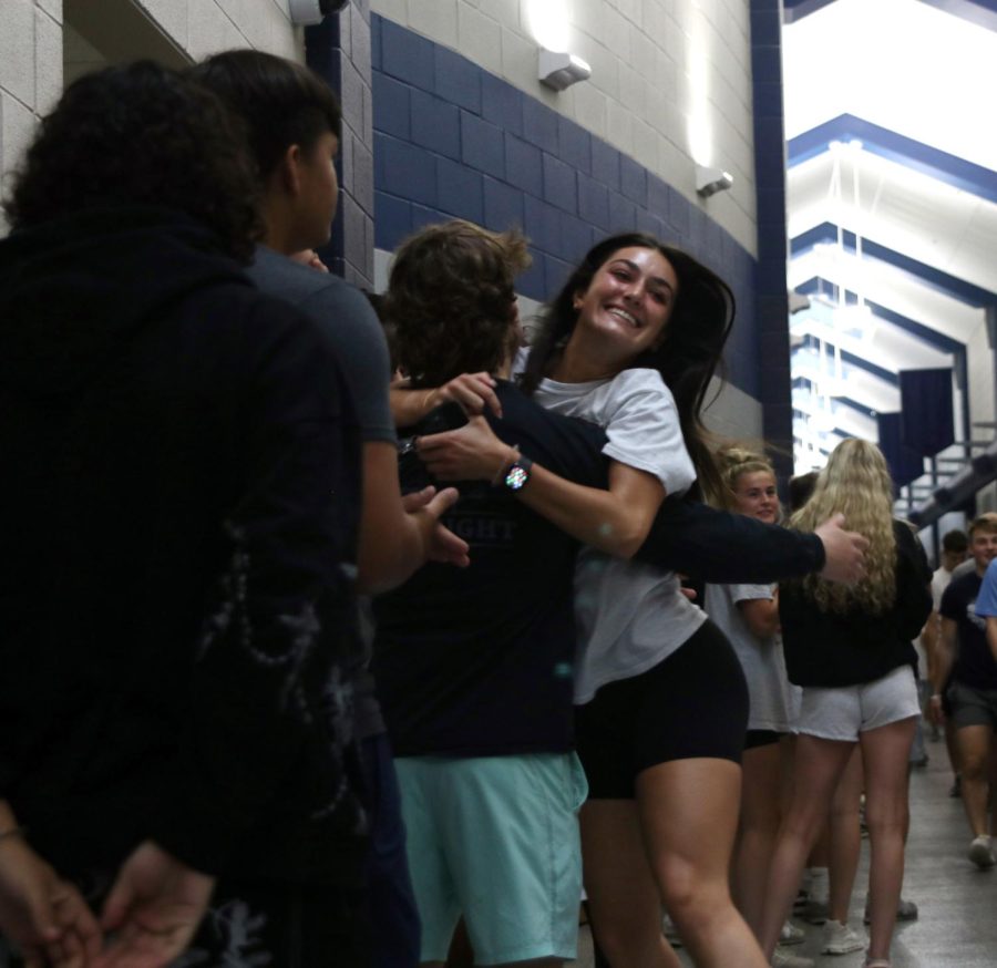 Smiling with excitement, senior Gracie Knight jumps into her brother, sophomore Gunnar Knights, arms.
