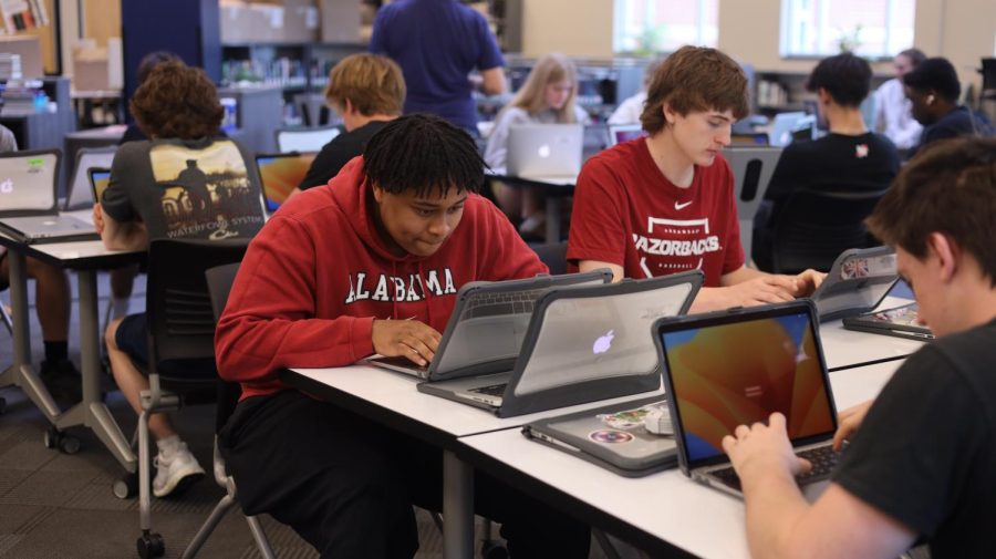 Junior Robert Hill sets up his new laptop in the media center Thursday, April 20.