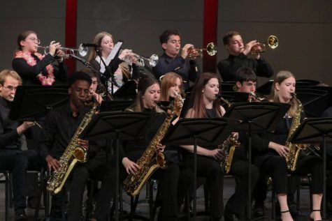 Seniors James Walker and Sienna DelBorrell play tenor saxophone, while senior McKenzie Keltner and junior Kate Marten play the alto saxophone at the spring band concert Tuesday, May 9.