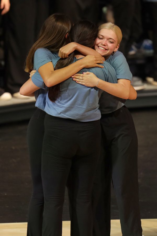 During the last song of the show, seniors Hayden Rider, Sidney Claeys and Bri Coup hug on stage