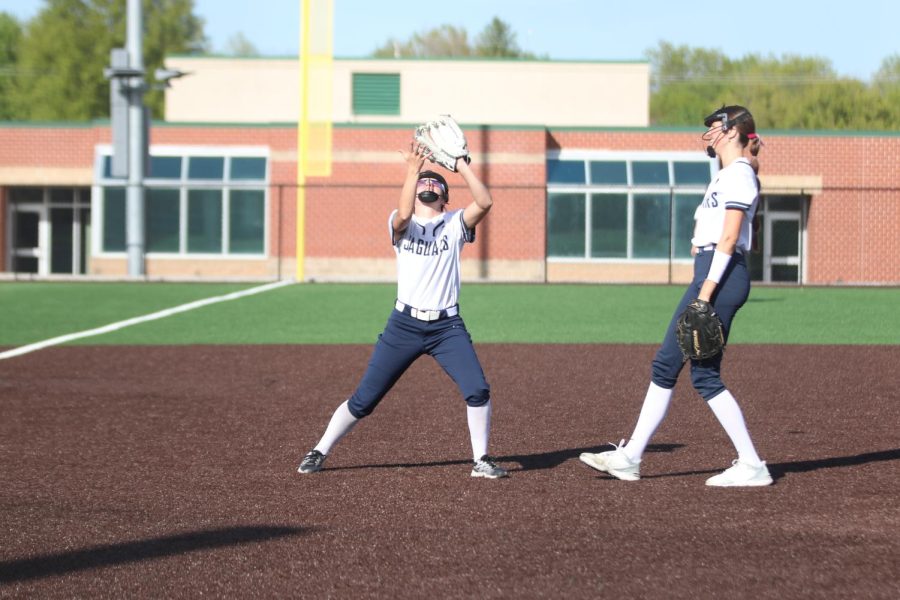 With her arms up, sophomore Ashley Bryant catches the fly ball. 
