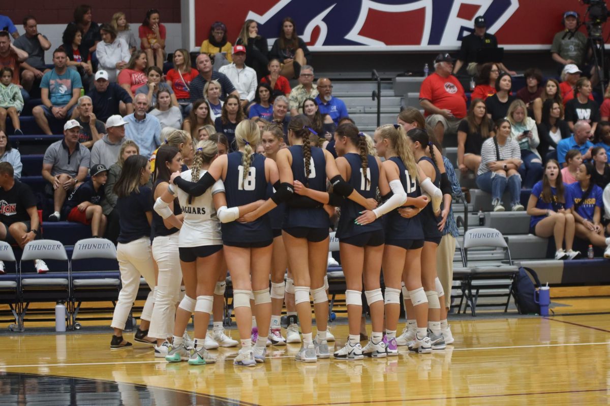 During a timeout, the team huddles together to hear advice from head coach Kylie Corneliusen about the rest of the game.