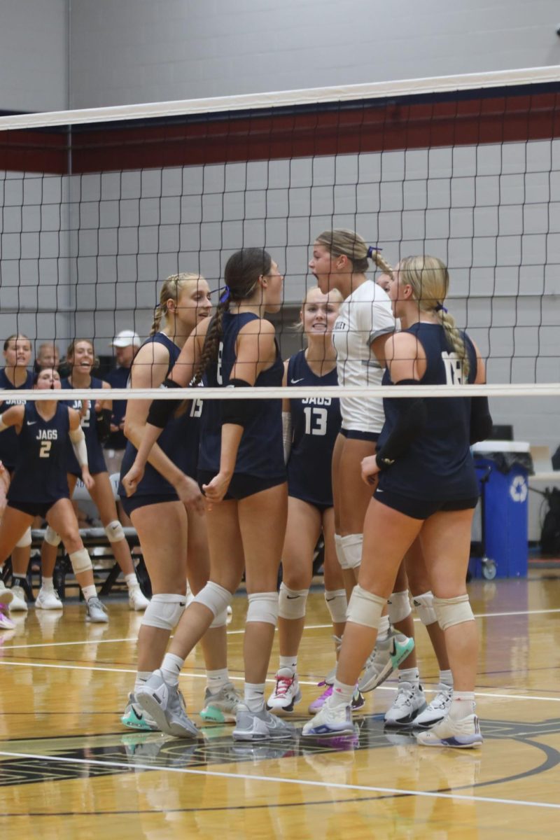 Celebrating after getting a point, senior Brooke Bellehumeur cheers with her teammates.