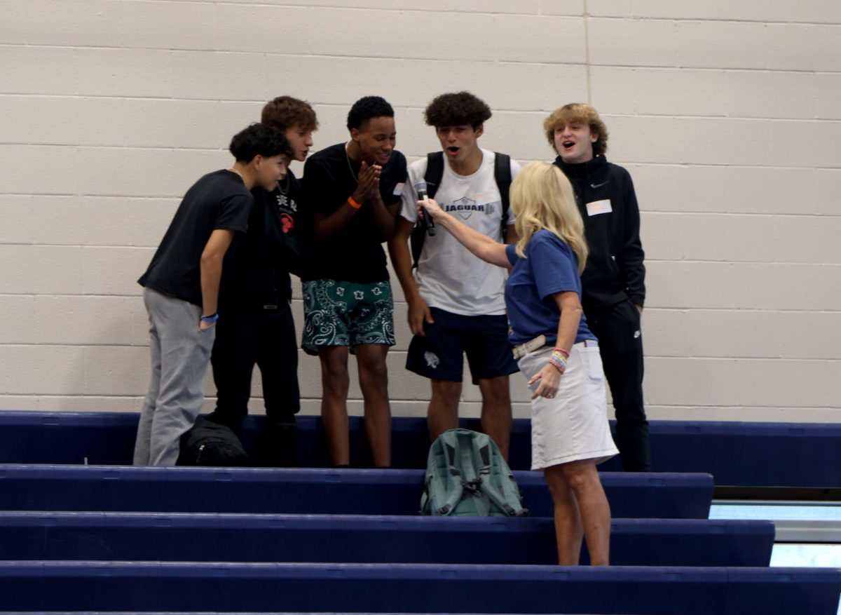 Principal Dr. Gail Holder and a group of freshman chant Hey, Hey, What do you say... Lets go Jags! during the assembly.