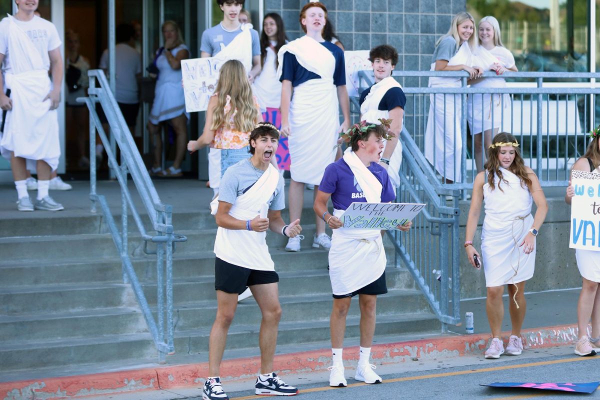 Filled with energy, sophomores Blake Jay and Gavin Hurt welcome and cheer for the incoming freshman.