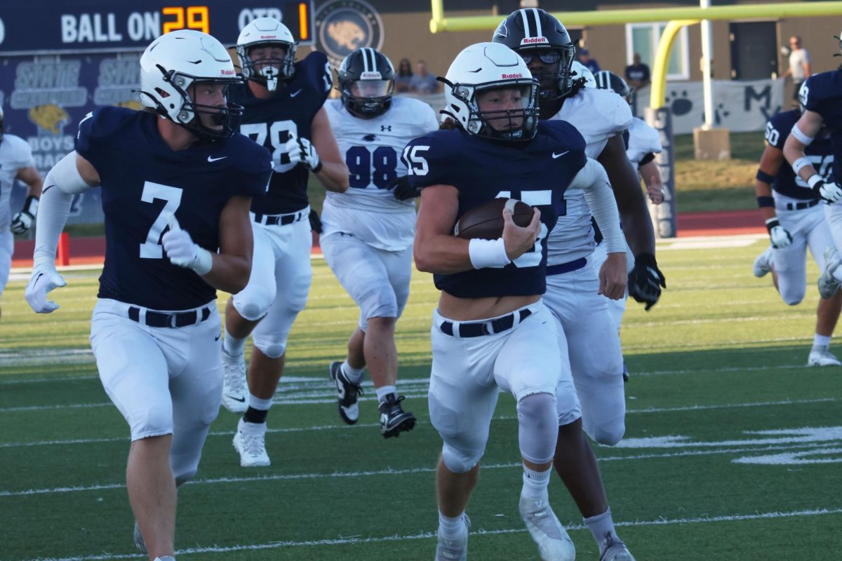 Senior Daniel Blaine runs down the field to score a touchdown. 