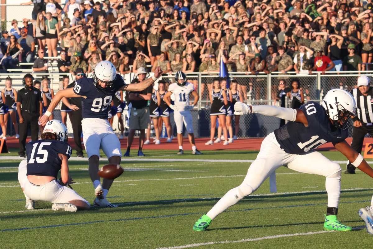 Senior Kentan Laughman kicks the ball to make a field goal.