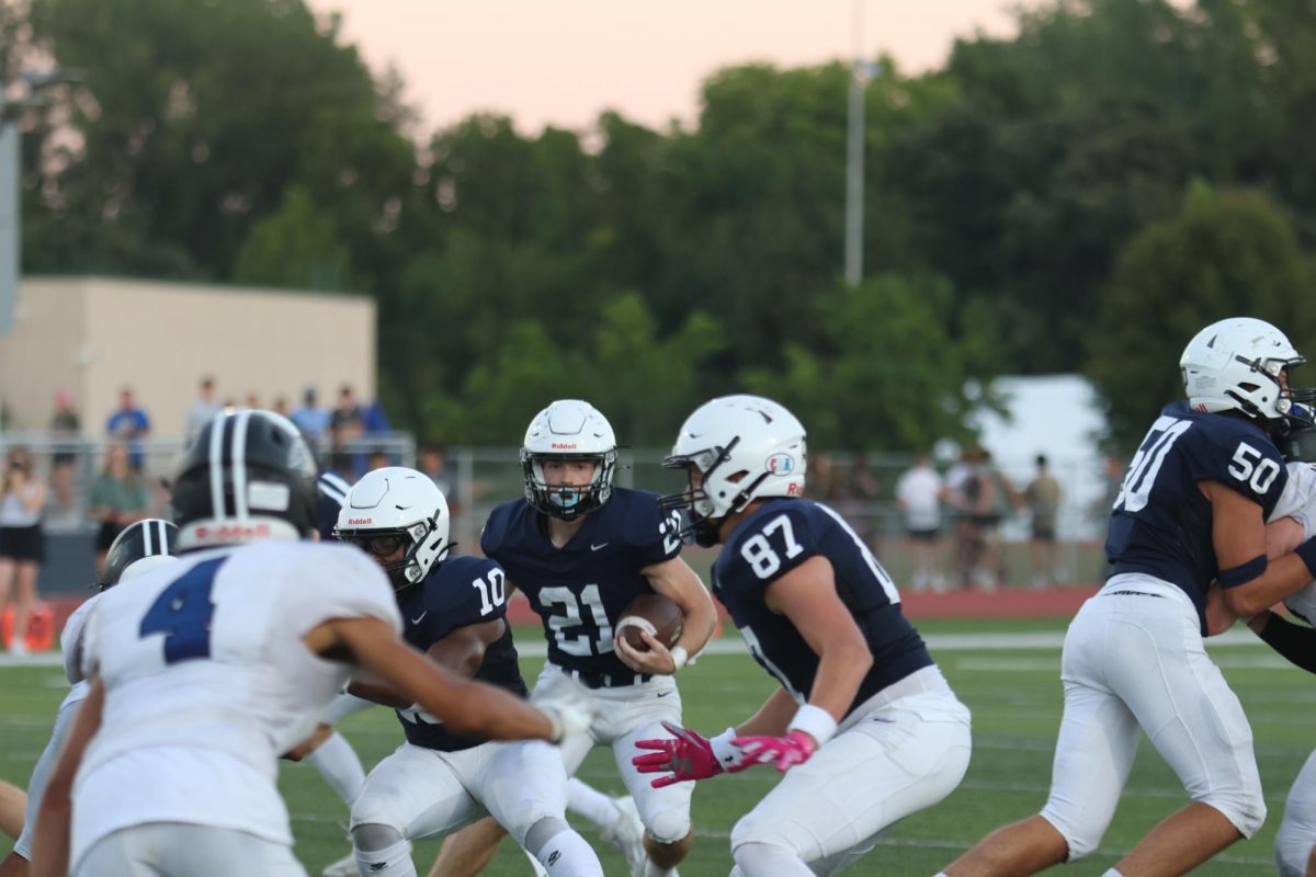 Senior Tristan Baker looks down the field so he can run down with the ball. 