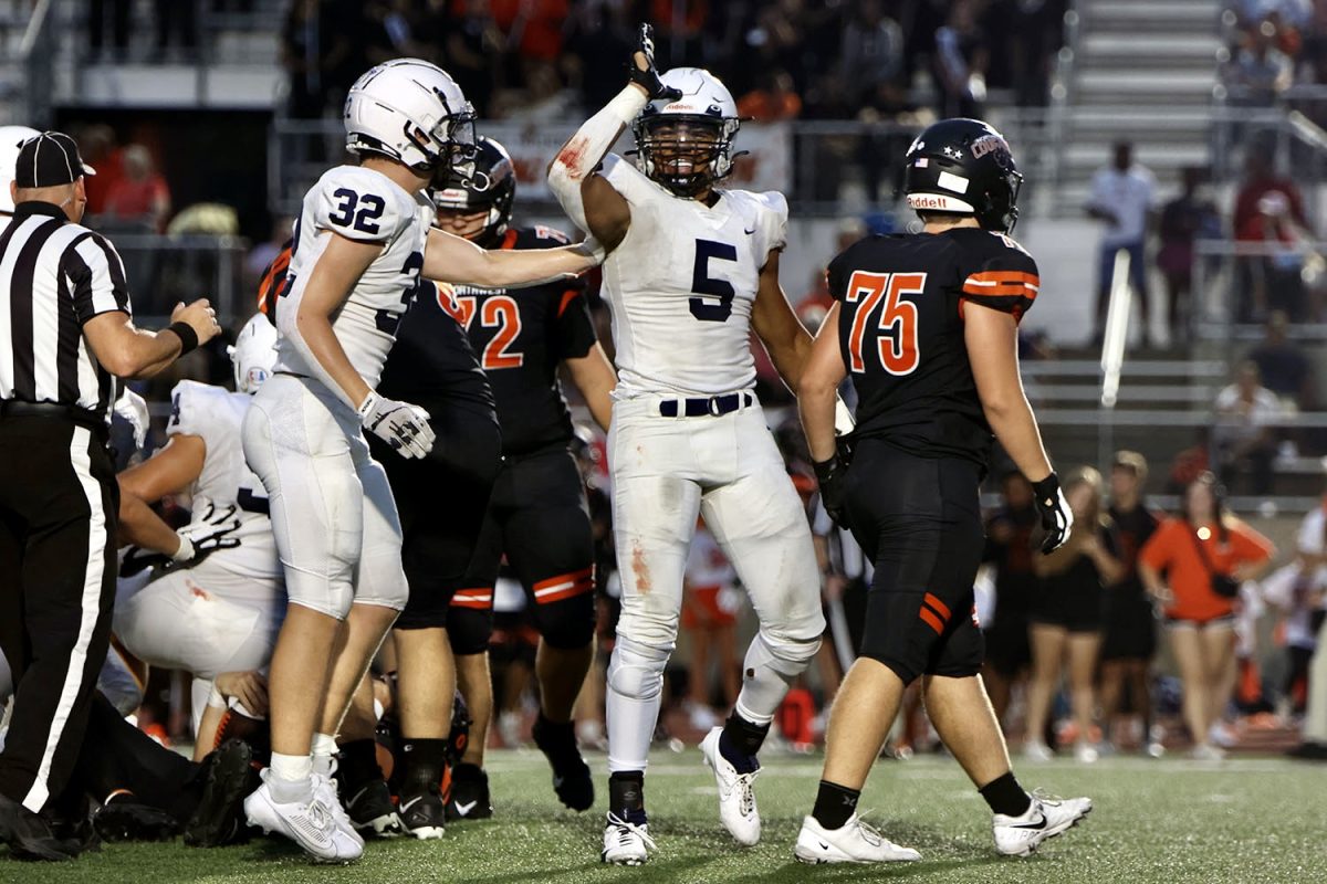 Throwing up the classic landshark celebration, junior Jayden Woods reacts to his sack.