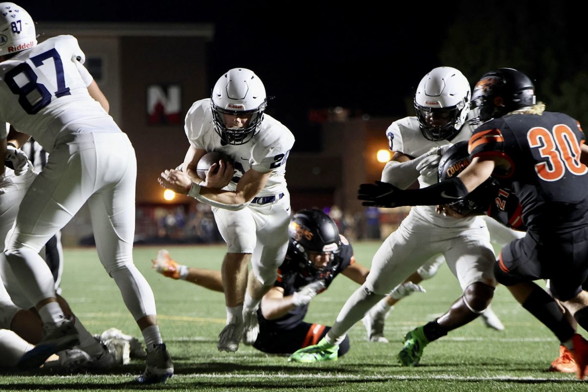 Crossing the goal-line, senior Tristan Baker secures the game winning touchdown. 