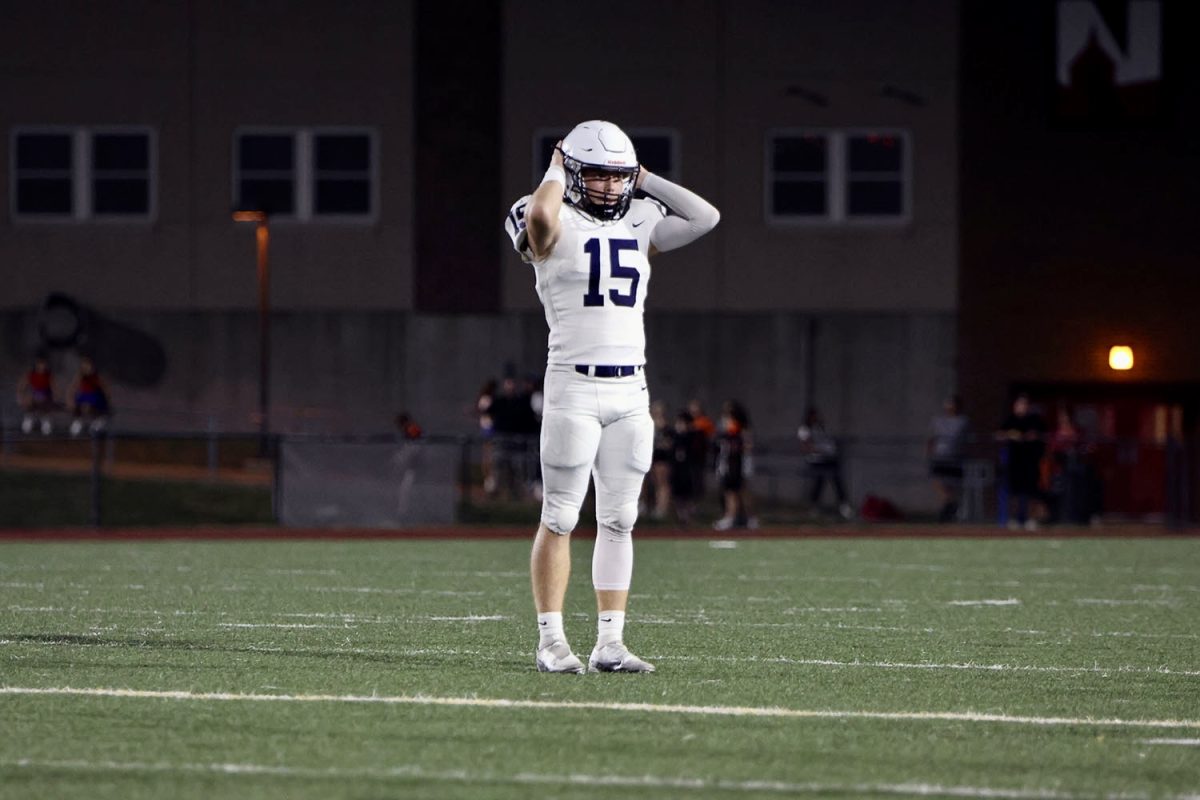 Upset about a dropped pass, senior Daniel Blaine freezes with his hands on his head.