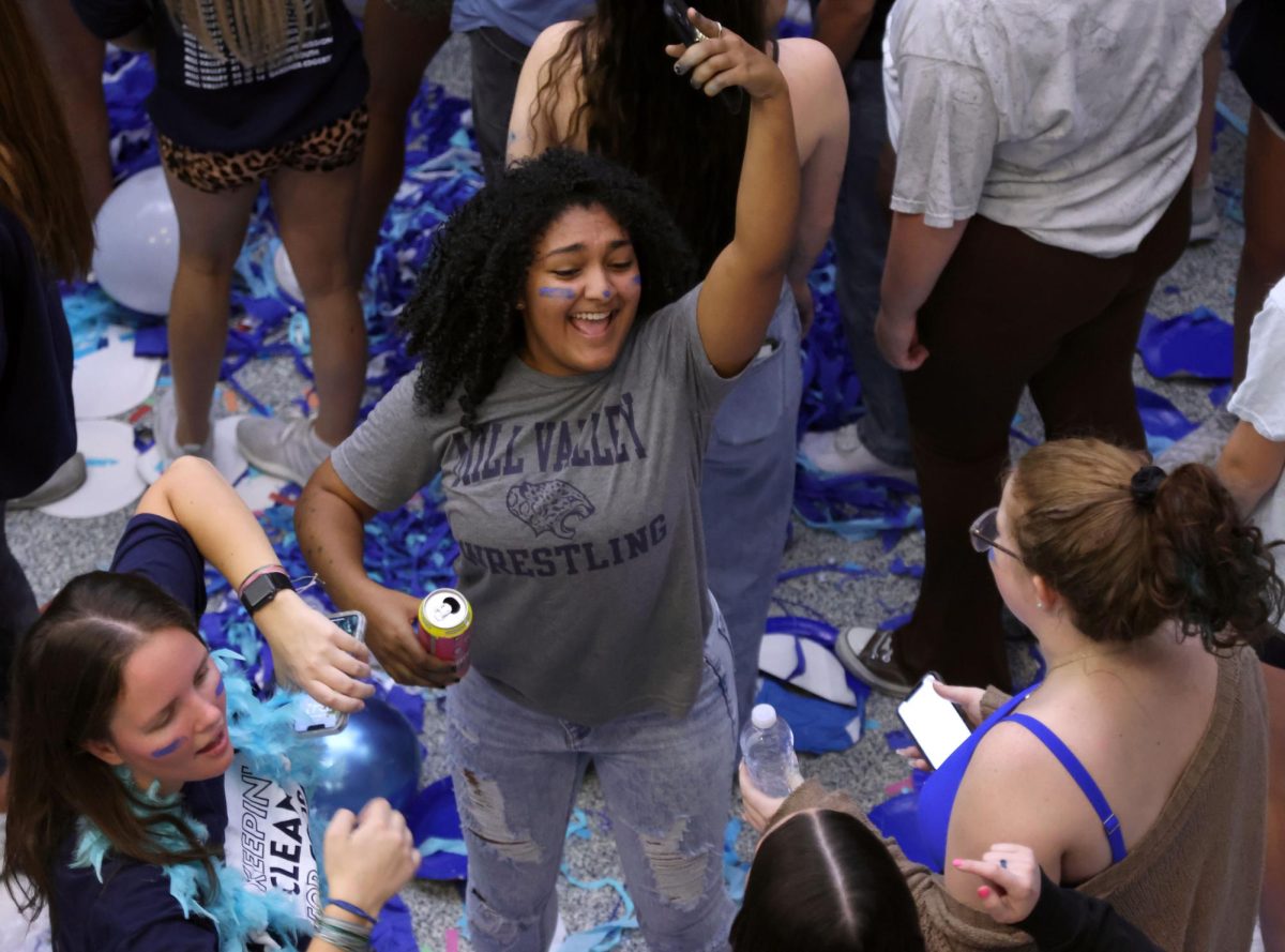 Dancing with a group of friends, senior Athena Solomon strikes a pose.