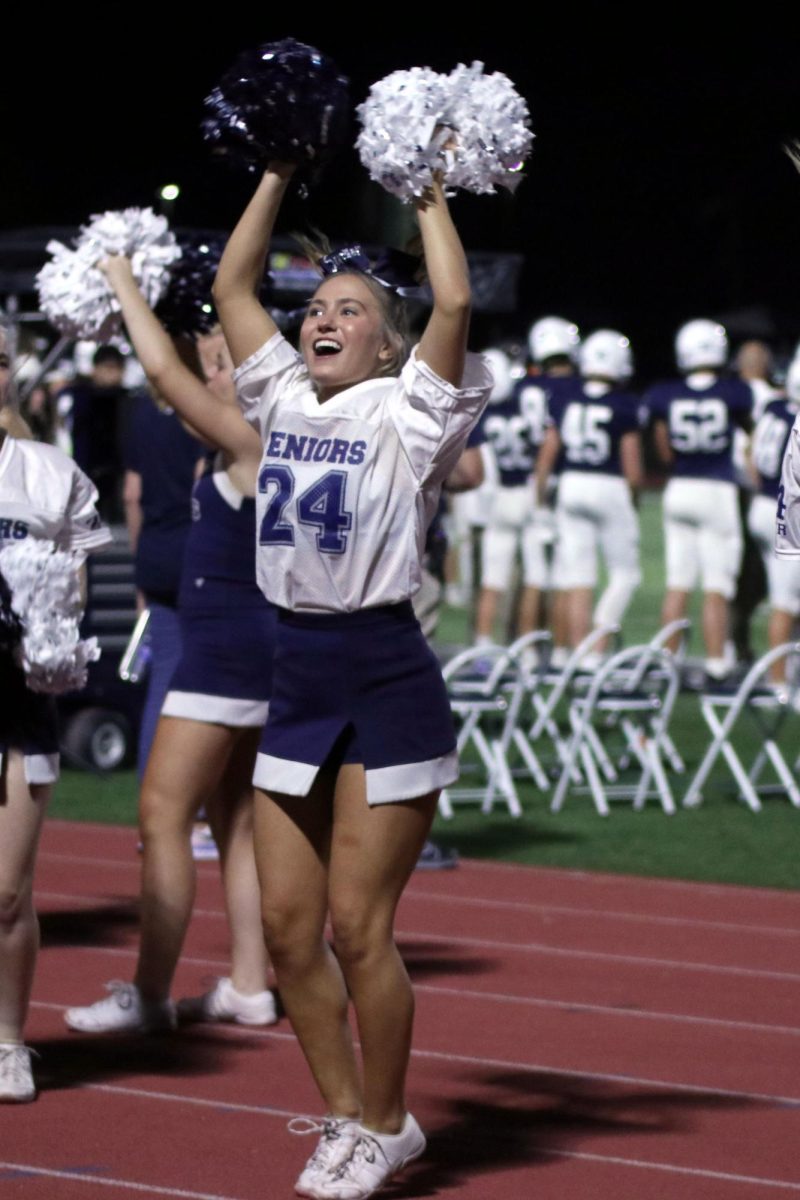 Jumping in the air, senior Jaiden Fisher performs the chant, Party to the crowd.